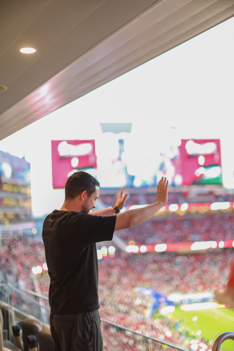 Crown Prince Hussein waves to Jordanian supporters from the stands during the nation's historic World Cup opener.