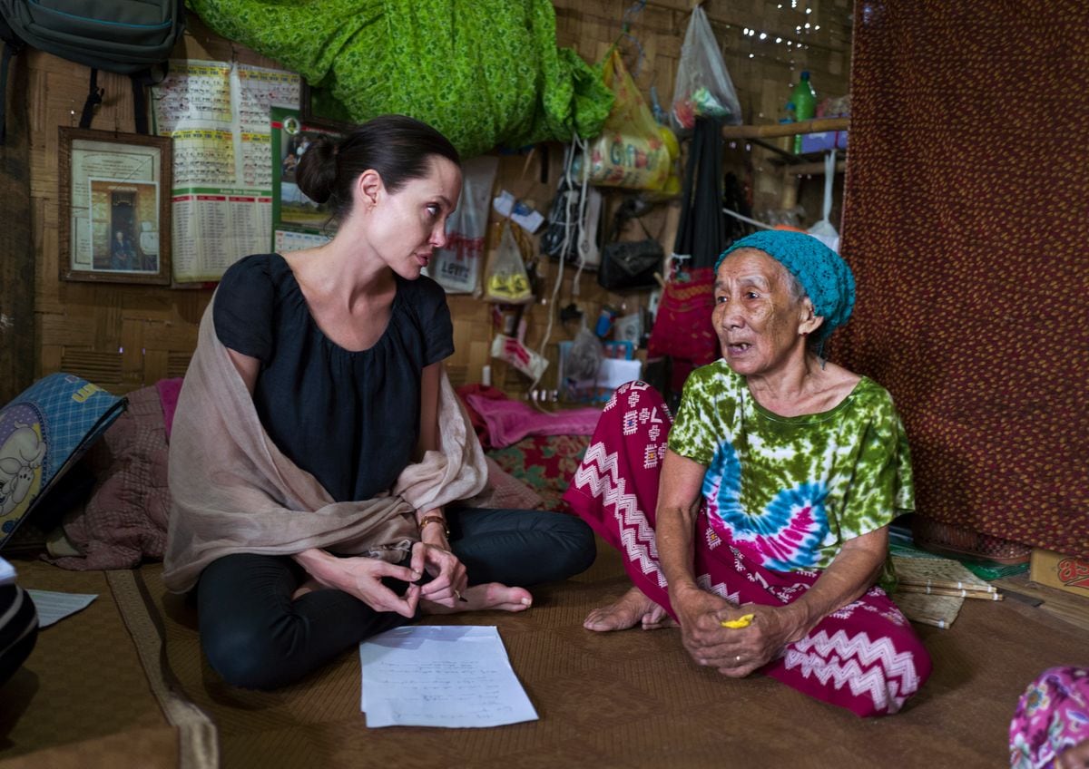Angelina meets a 90-year-old woman during a visit to Ja Mai Kaung Baptist refugee camp on July 30, 2015, in Myitkyina, Myanmar