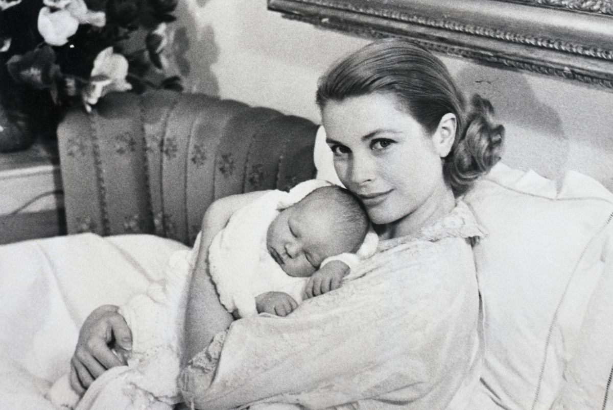 Princess Grace of Monaco poses with her newborn son, Prince Albert.