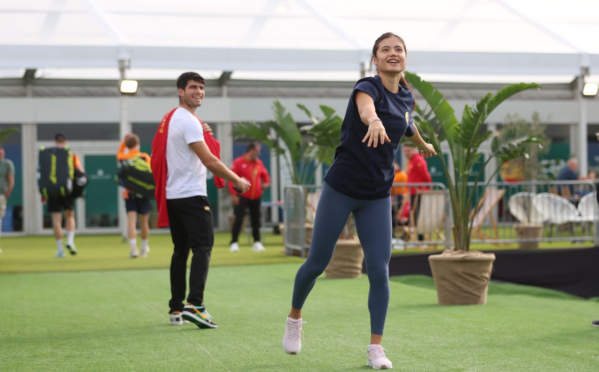 Carlos Alcaraz interacts as Emma Raducanu warms up during the Billie Jean King Cup Finals at Palacio de Deportes Jose Maria Martin Carpena on November 17, 2024, in Malaga, Spain. 