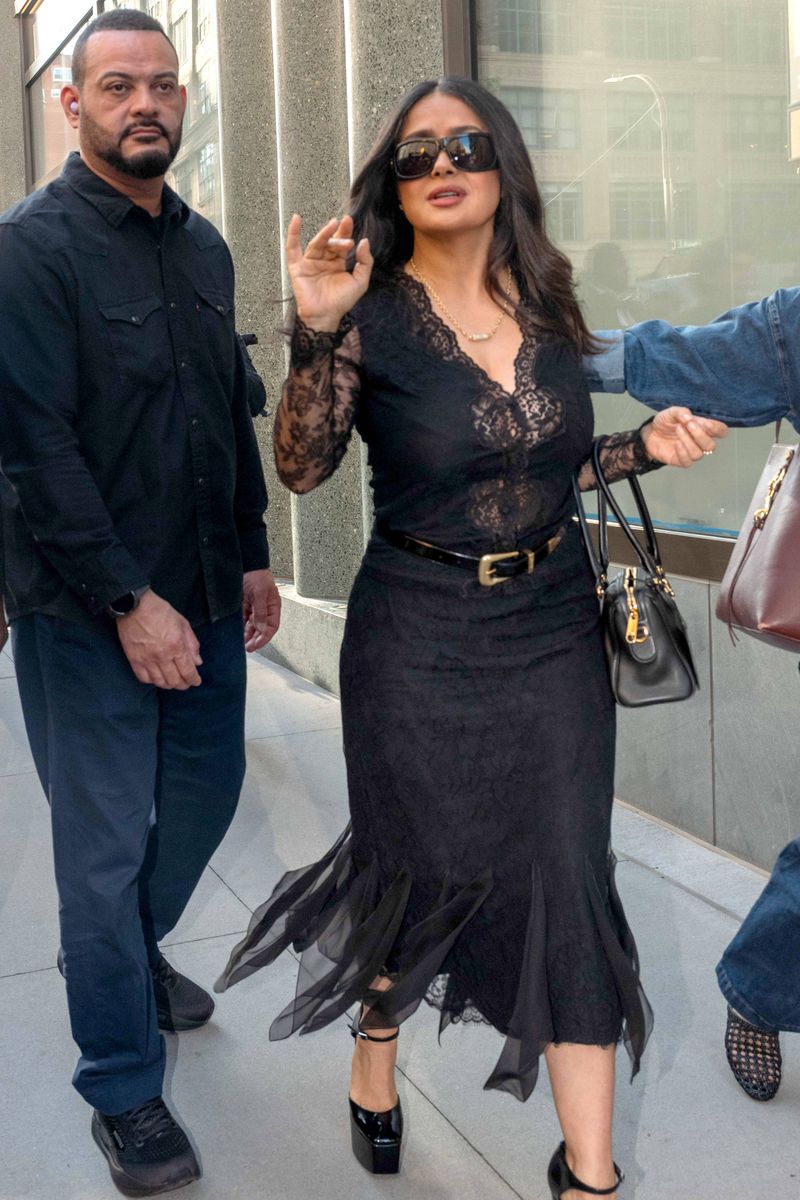 The 60-year-old actress embraced romantic glamour in a sheer black lace top paired with a coordinating midi skirt and towering platform heels.
