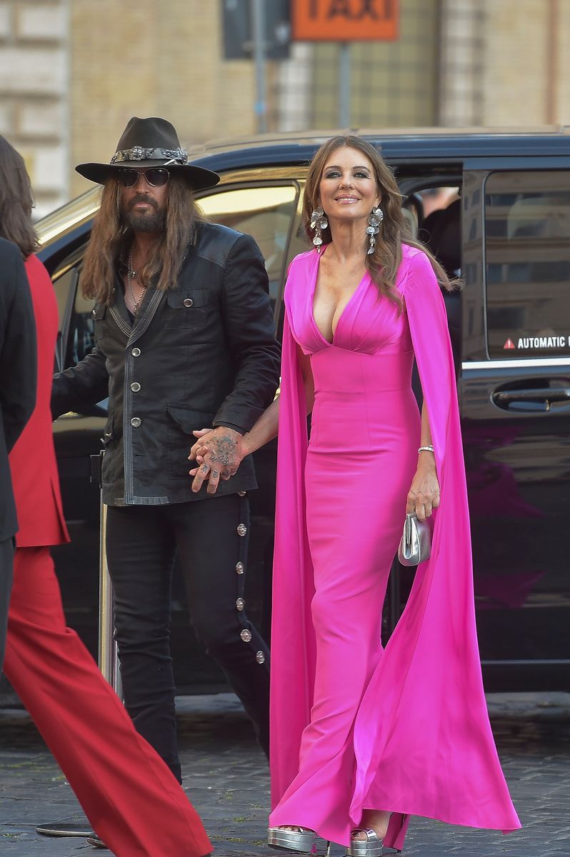  Billy Ray Cyrus and Elizabeth Hurley are seen arriving at the opening of the new Valentino Garavani space on May 24, 2025 in Rome, Italy. 
