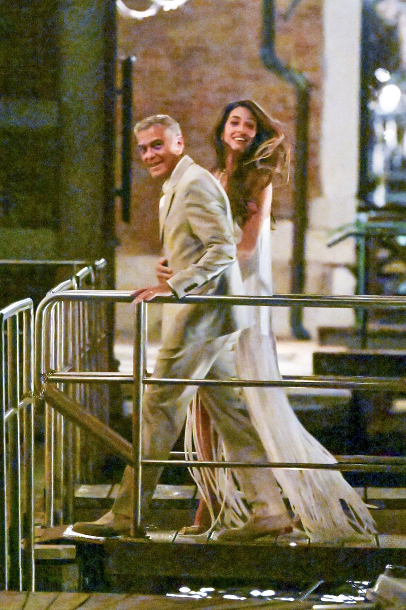 Amal completed her glamorous date-night look with metallic gold pumps and voluminous brunette waves.