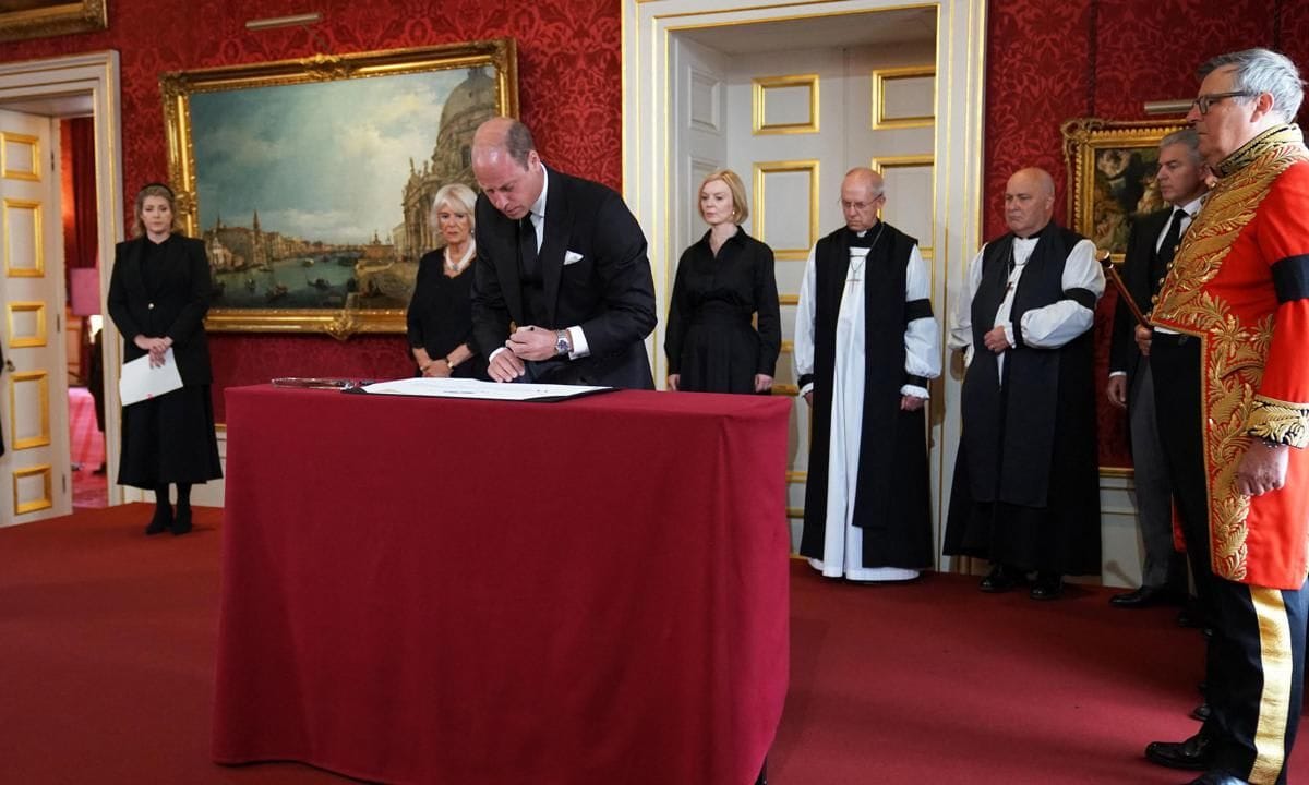 Britain's Prince William, Prince of Wales signs the Proclamation of Accession of King Charles III, watched by (L R) Lord President of the Council Penny Mordaunt, Britain's Camilla, Queen Consort, Britain's Prime Minister Liz Truss, Archbishop of Canterbury, Justin Welby, Archbishop of York, Stephen Cottrell, Lord Chancellor of the Privy Council Brandon Lewis and Earl Marshal, Edward Fitzalan Howard, the Duke of Norfolk during a meeting of the Accession Council inside St James's Palace in London on September 10, 2022, to proclaim Britain's King Charles III as the new King.   Britain's Charles III was officially proclaimed King in a ceremony on Saturday, a day after he vowed in his first speech to mourning subjects that he would emulate his "darling mama", Queen Elizabeth II who died on September 8. (Photo by Kirsty O'Connor / POOL / AFP) (Photo by KIRSTY O'CONNOR/POOL/AFP via Getty Images)