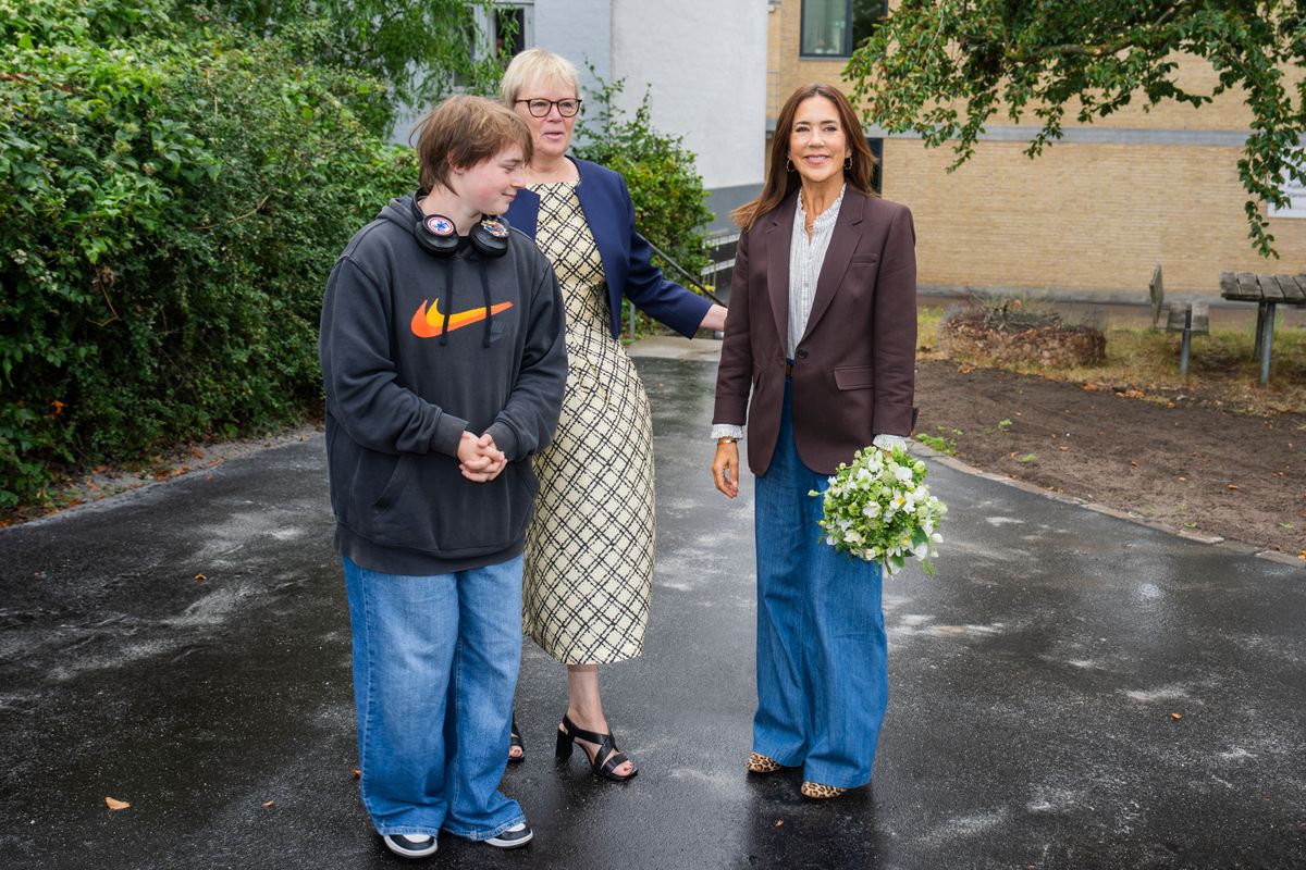 Queen Mary embraced relaxed royal style in wide-leg jeans, a crisp white blouse and a tailored brown blazer for the outing.