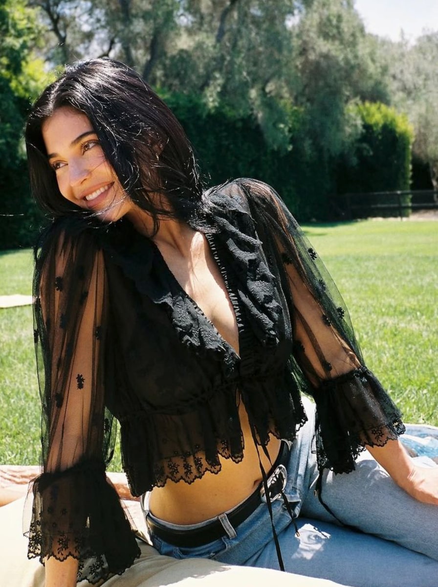 Kylie Jenner poses in see-through lace and low-rise jeans in intimate fall look