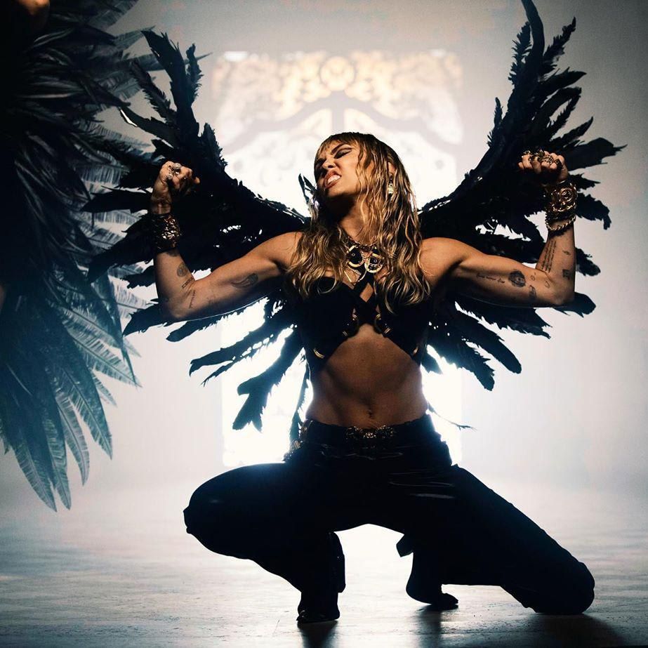 Miley Cyrus in harness top for music video