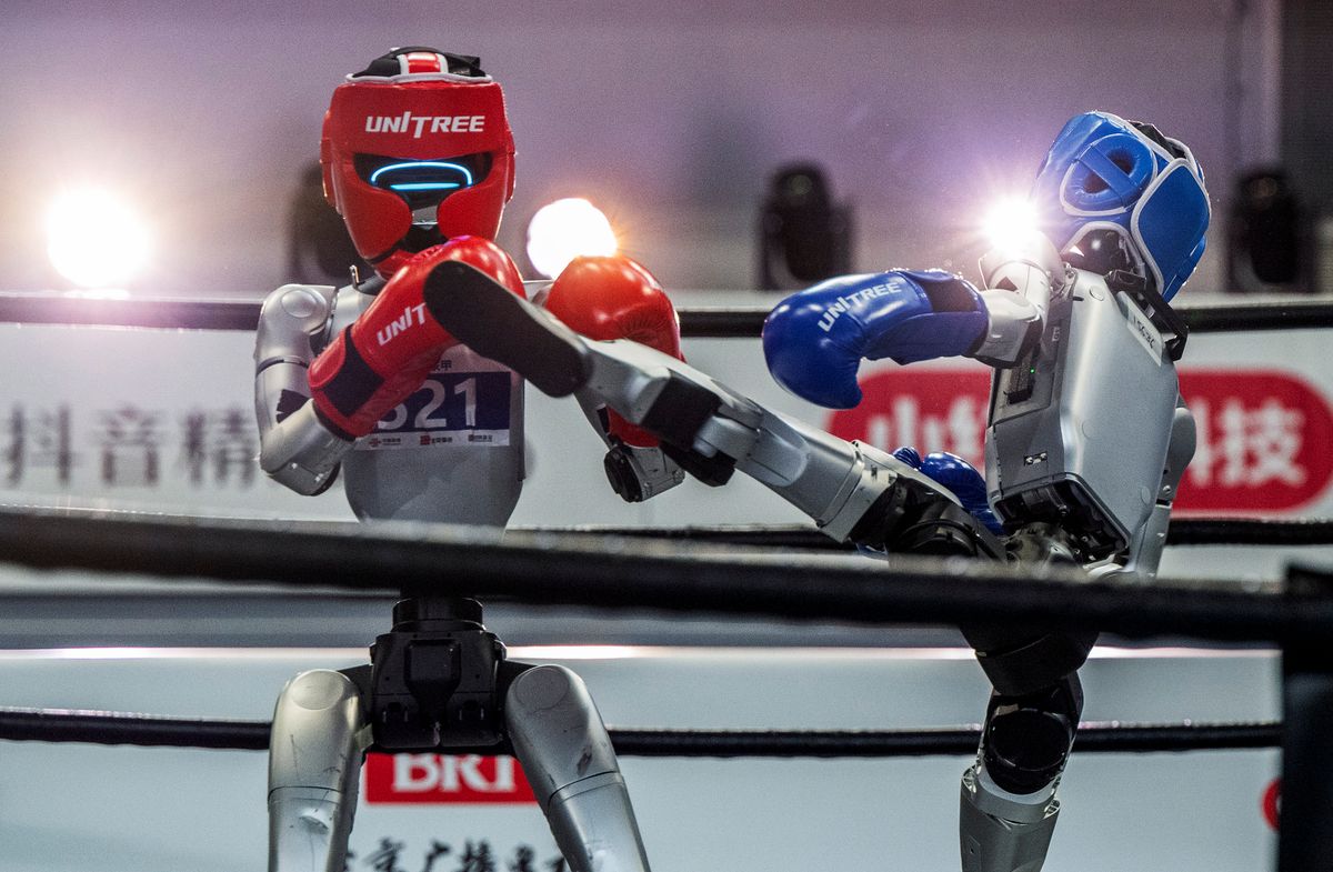 A humanoid robot kicks another in a fight during a kickboxing match at the 2nd World Robot Games