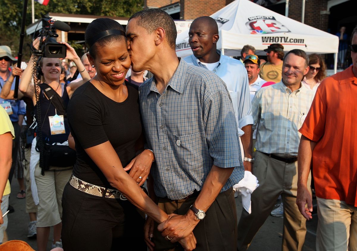 DES MOINES, IA - AUGUST 16:  Democratic Presidential Candidate Senator Barack Obama (D-IL) gives his wife Michelle a playful kiss as they tour the Iowa State Fair August 16, 2007 in Des Moines, Iowa. The fair runs until August 19th and is expected to draw about 1 million people. John Edwards also made a campaign stop at the fair today.  (Photo by Scott Olson/Getty Images) 