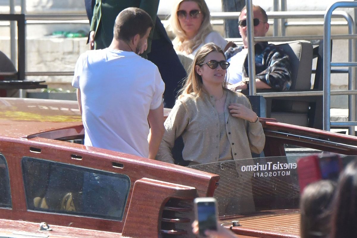 The former footballer was photographed aboard a boat as the couple took in the sights along the Grand Canal during their trip through the city.
