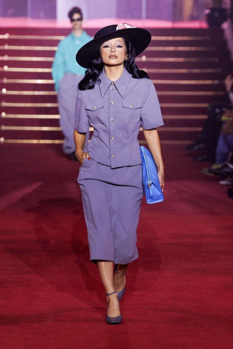 
Becky G graces the runway at Willy Chavarria's Spring-Summer 2026 show during Paris Fashion Week Menswear, wearing a chic lavender suit paired with a black wide-brimmed hat and a blue clutch.