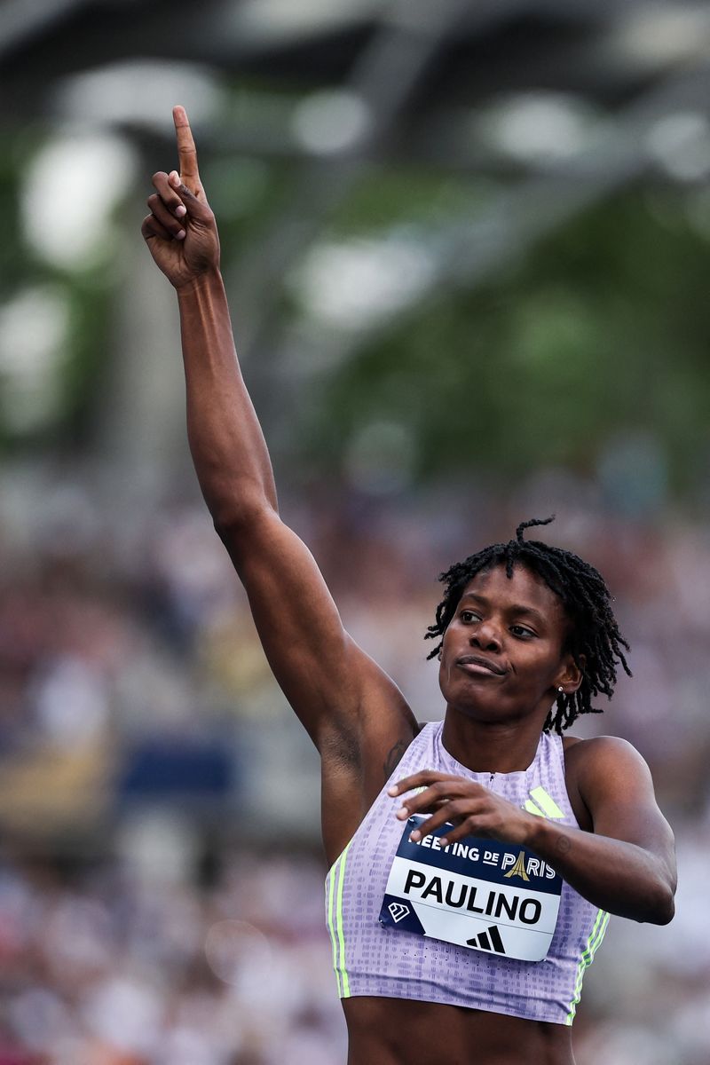 First-placed Dominican Republic's Marileidy Paulino celebrates as she crosses the finish line to win the women's 400m during the IAAF Diamond League athletics meeting