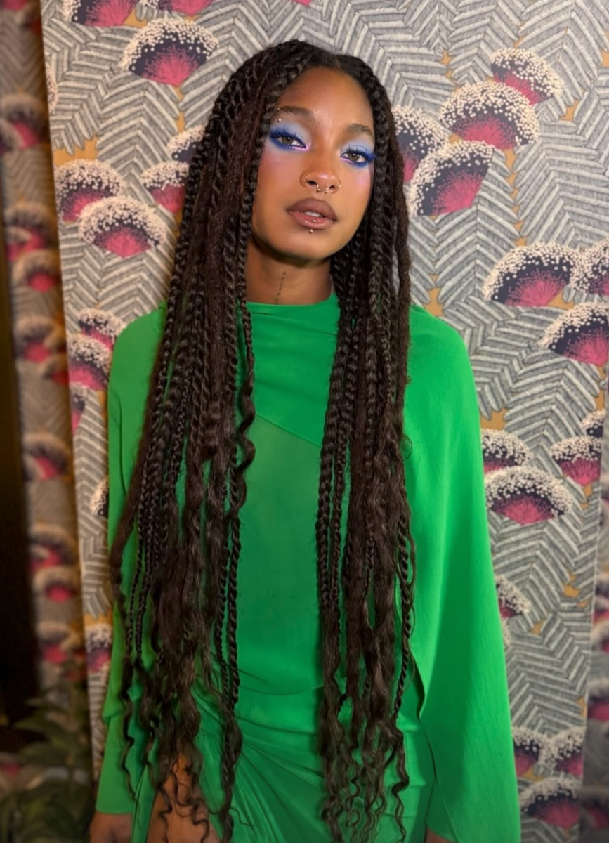 The singer completed the colorful look with waist-length braids, electric blue eye makeup and metallic gold heels.