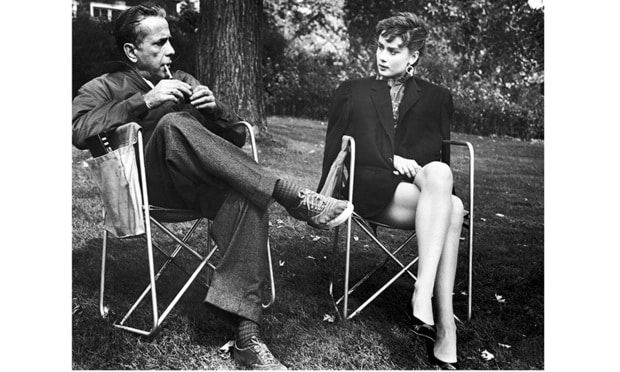 Audrey played the chauffeur's daughter in Billy Wilder's rags-to riches tale <I>Sabrina</I>. Here she is looking effortlessly chic with co-star and love interest Humphrey Bogart on set. "She's a wispy, thin little thing," Wilder wrote, "but you're really in the presence of somebody."
Photo: WENN