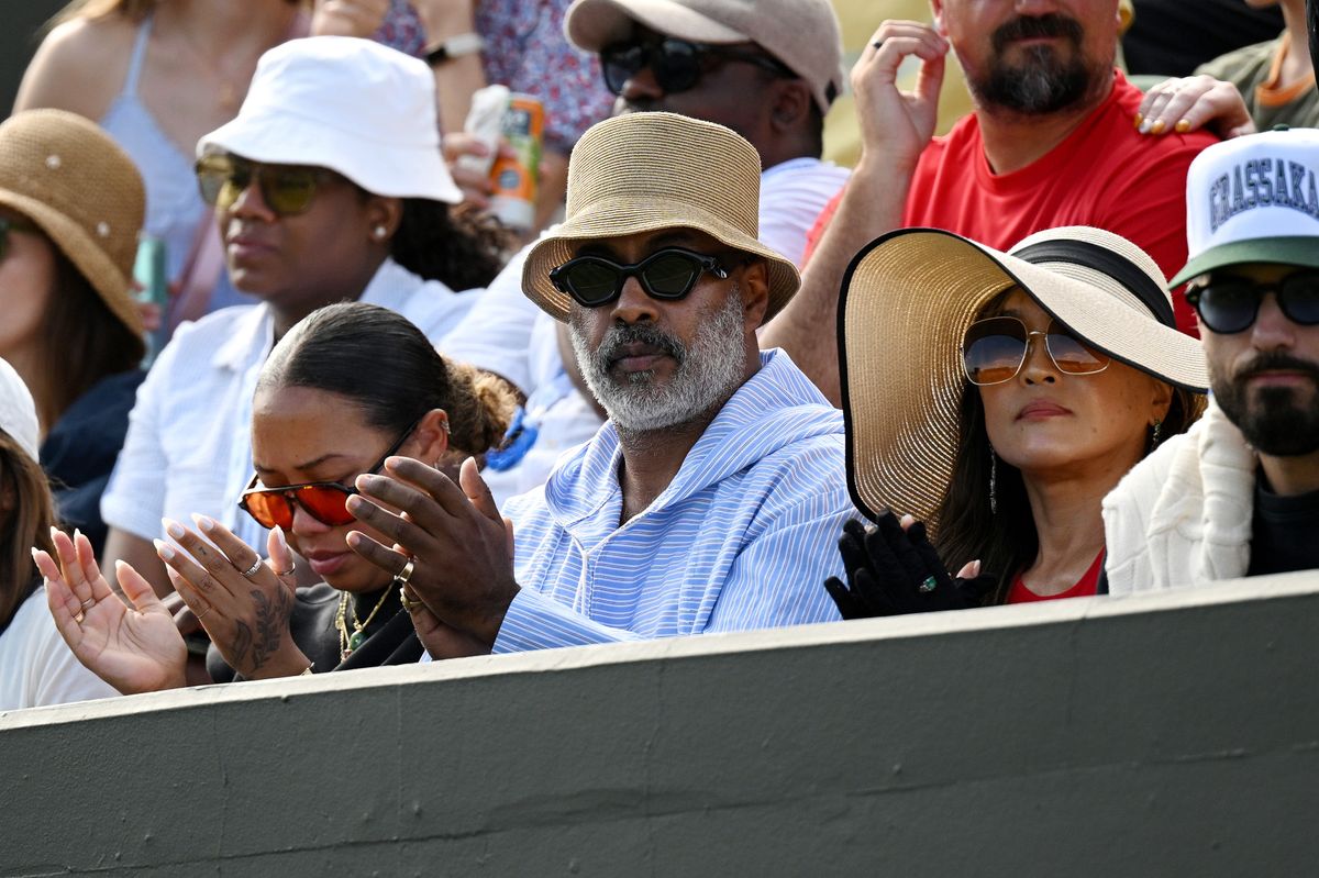 Naomi Osaka's father, Leonard Francois, and mother, Tamaki Osaka, applaud whilst in attendance for the Ladies' Singles first round match between Elsa Jacquemot of France and Naomi Osaka of Japan