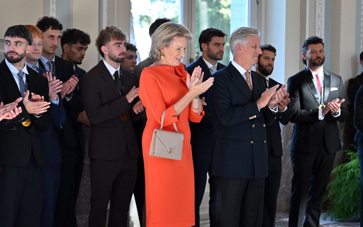 Queen Mathilde brightens up palace reception in an orange dress with a playful twist