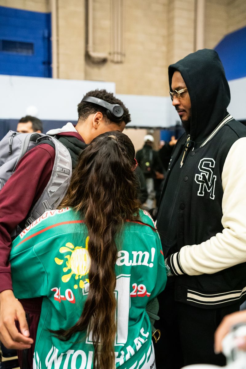 Kiyan Anthony greets his parents Lala Anthony and Carmelo Anthony after the Sierra Canyon vs Christ The King boys basketball game.