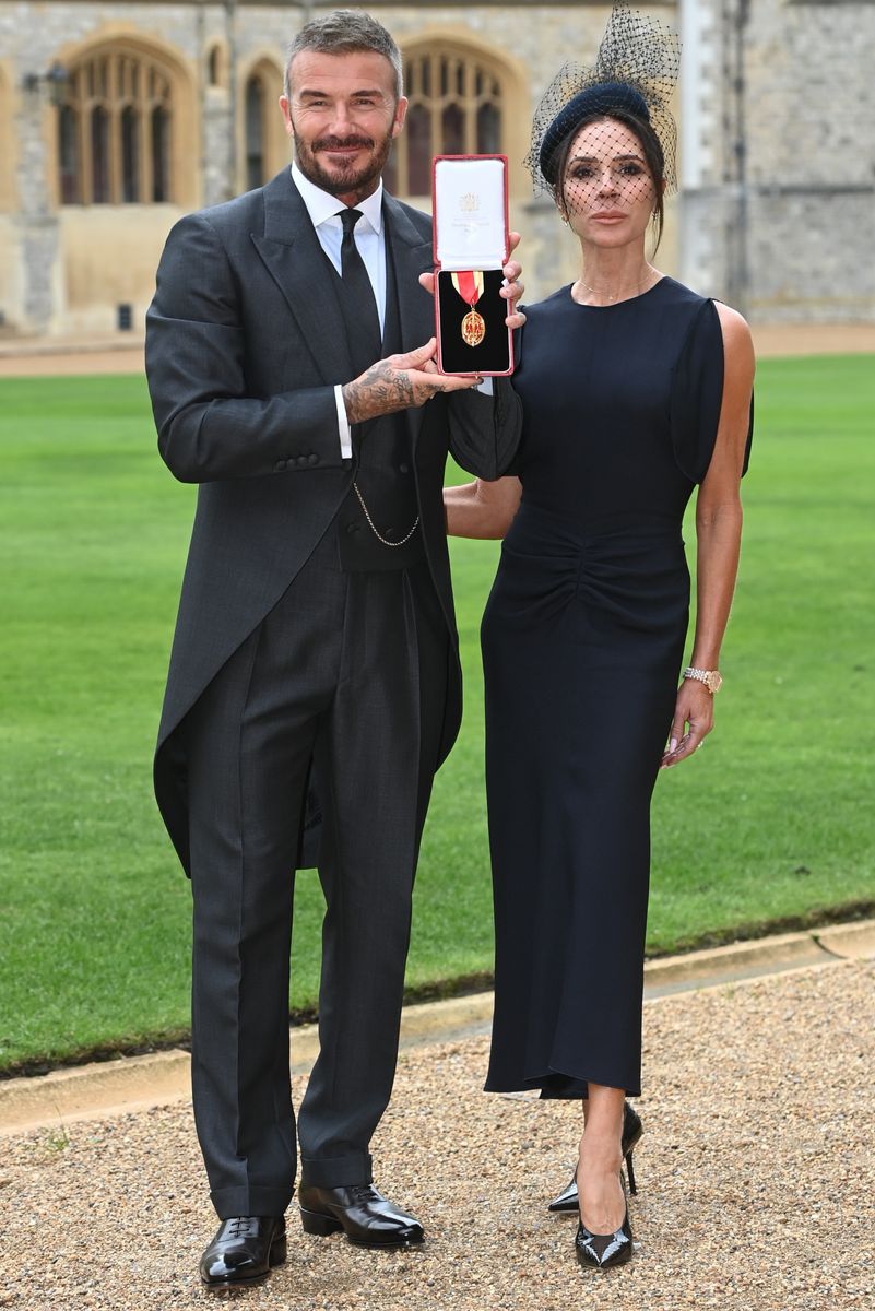 Sir David Beckham with wife Victoria after he was made a Knight Bachelor at an investiture ceremony at Windsor Castle on November 4, 2025 in Windsor, England.