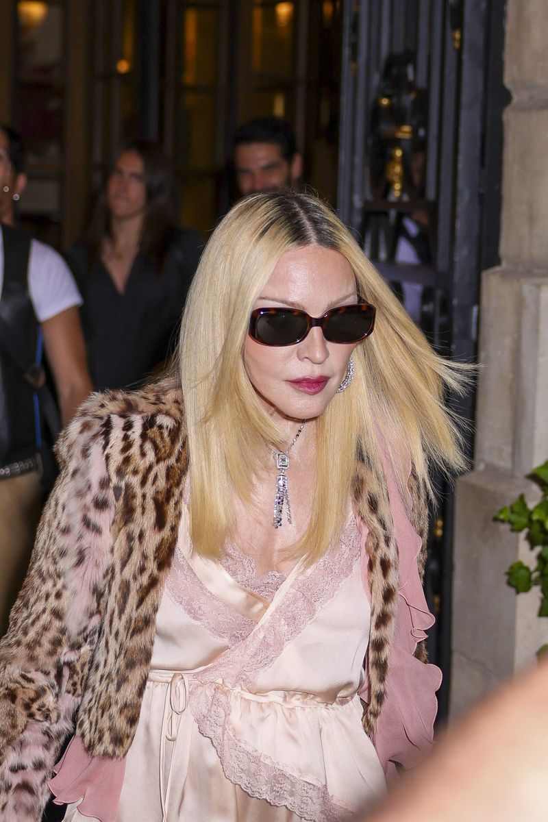 Madonna's romantic blush-toned ensemble featured delicate lace accents and soft ribbon ties that elevated the look.