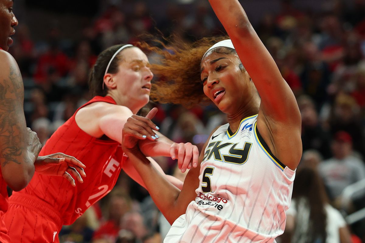  Angel Reese #5 of the Chicago Sky takes a hard foul from Caitlin Clark #22 of the Indiana Fever in the second half during the Fever's home opener at Gainbridge Fieldhouse on May 17, 2025 in Indianapolis, Indiana. 