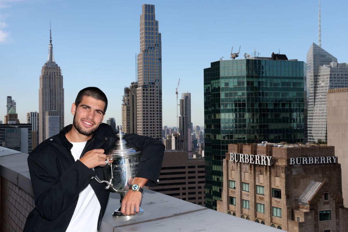 US Open 2025 champion Carlos Alcaraz poses with the men’s singles trophy on the roof of the Lotte New York Palace Hotel after defeating Jannik Sinner in New York