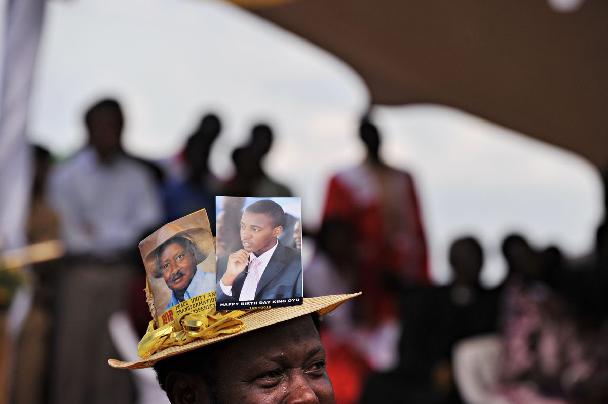 A Ugandan man wears a hat featuring King Oyo and President Yoweri Museveni during the king’s coronation in Fort Portal on April 17, 2010.