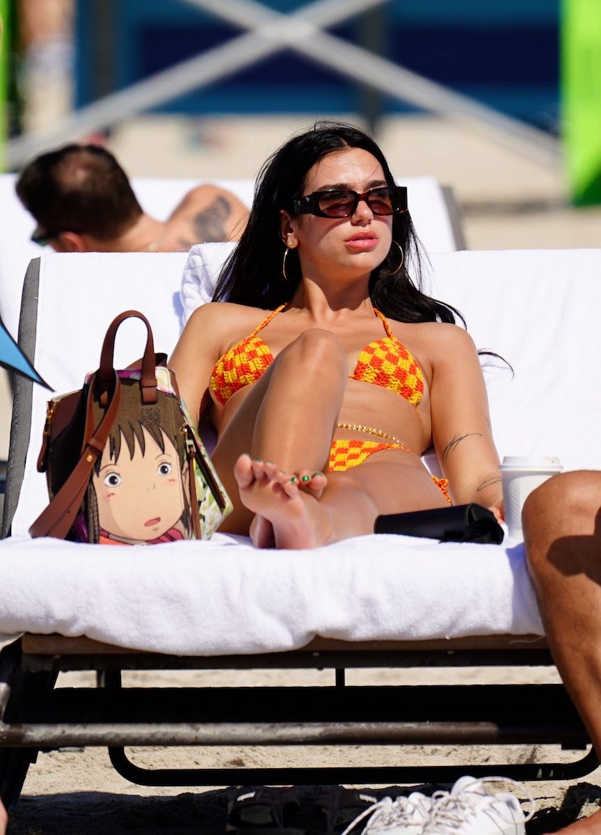 Dua Lipa wore an orange triangle top crochet bikini.