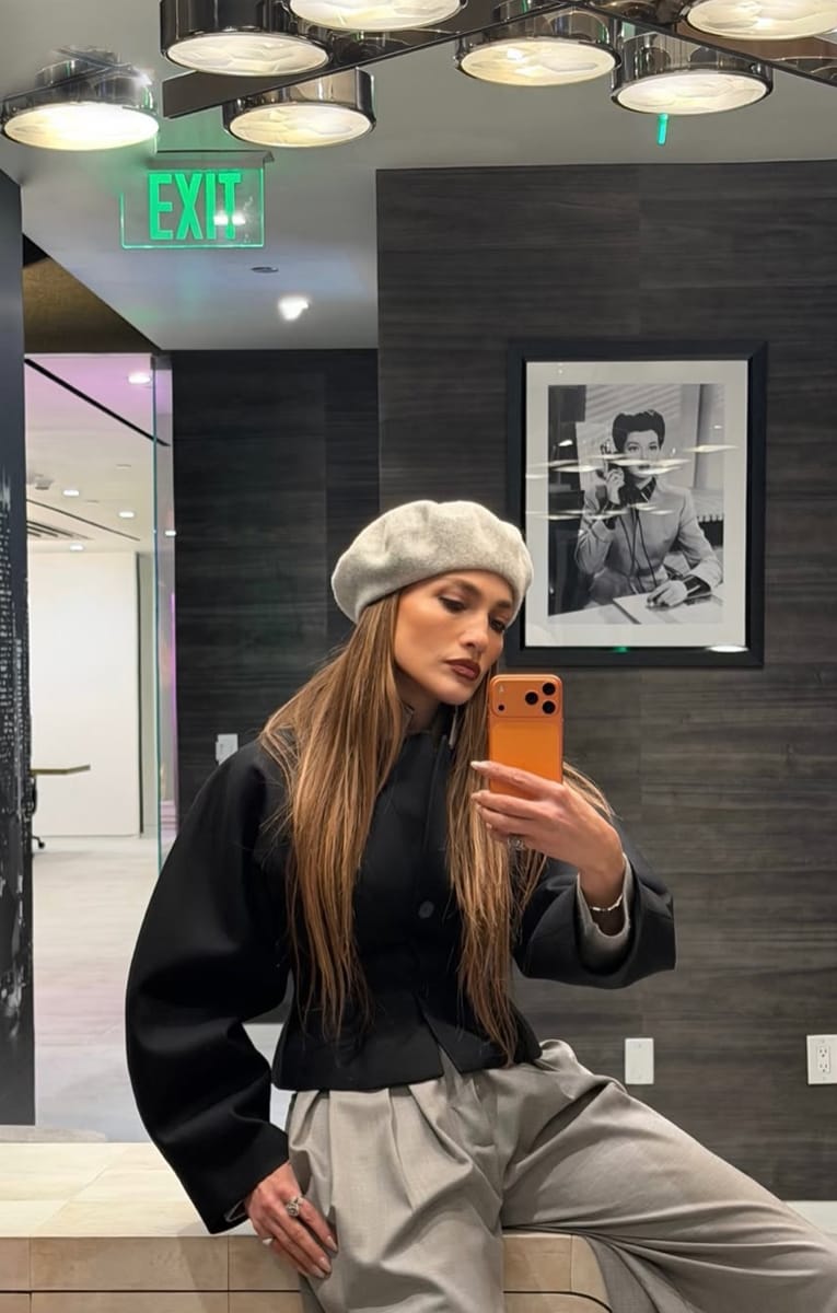 J.Lo donned a gray beret paired with matching ultra-pleated trousers.