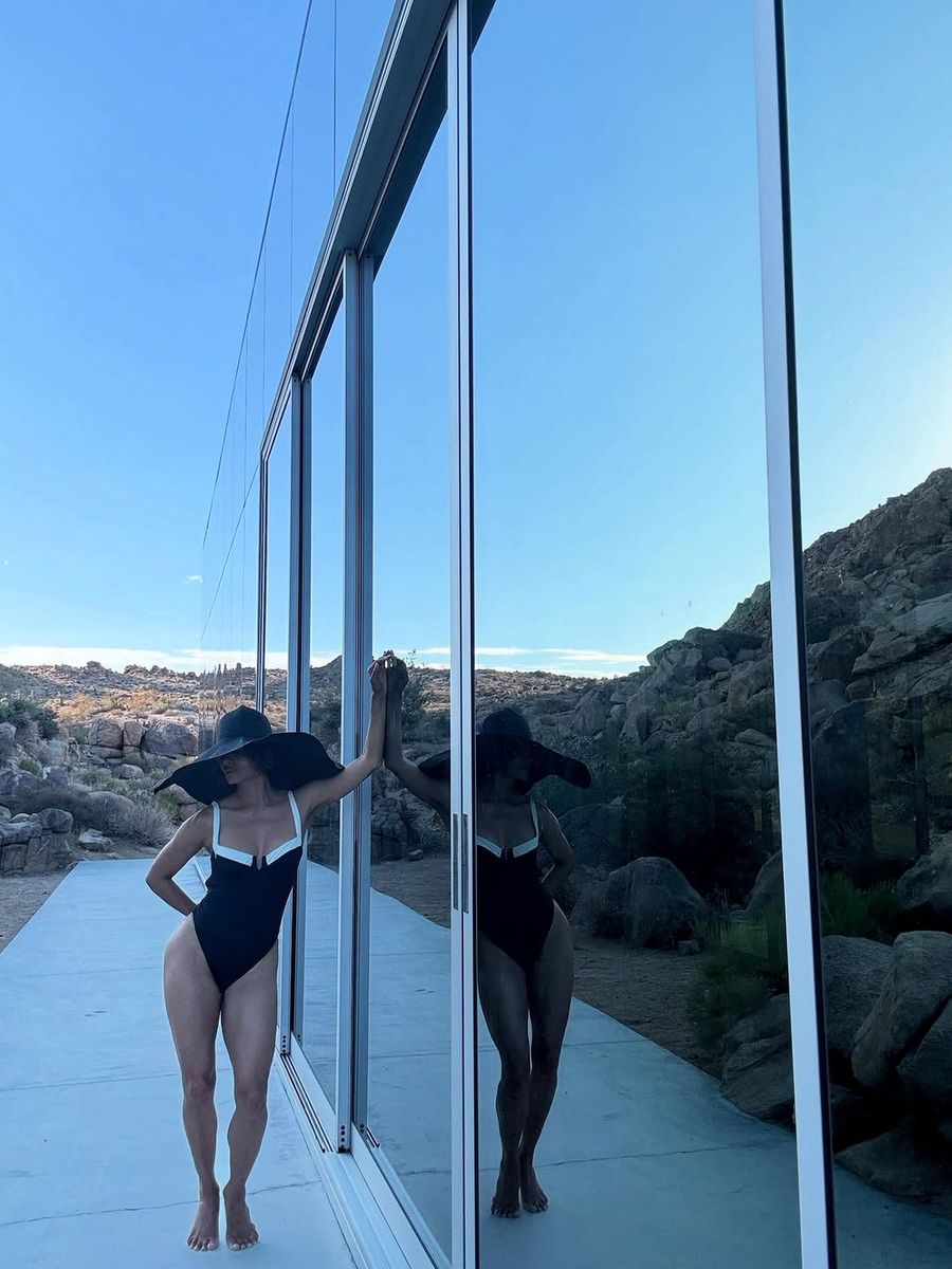 Halle Berry stuns in a plunging one-piece bikini with a giant sun hat during a desert getaway