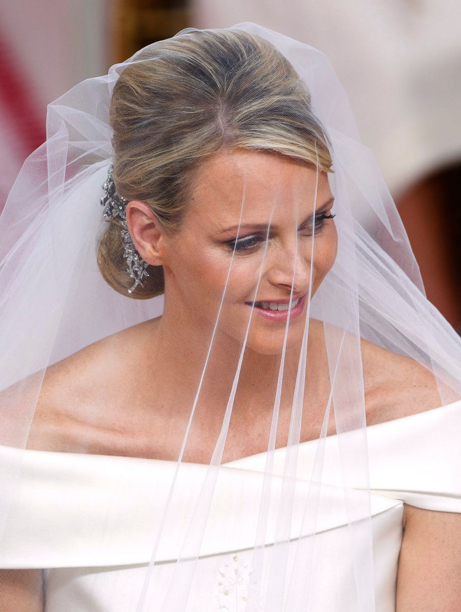 Princess Charlene of Monaco sits in front of the altar during her religious wedding with Prince Albert II of Monaco