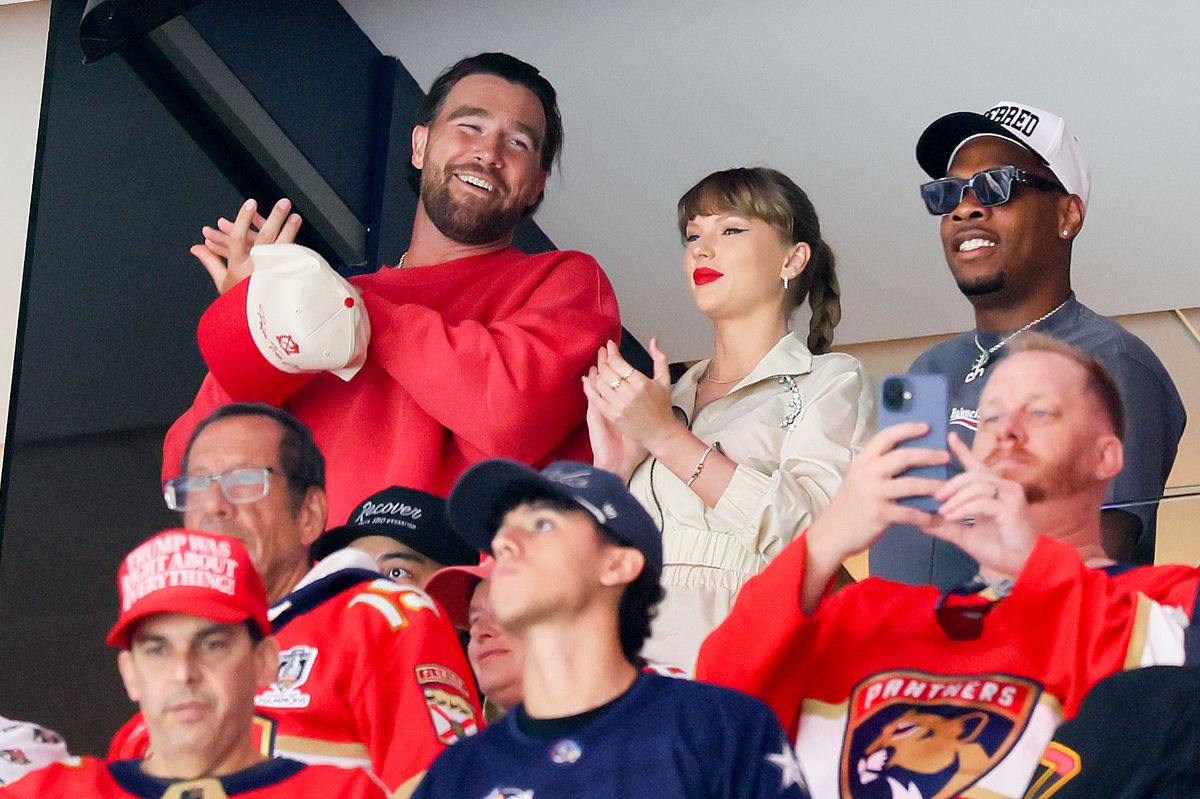 Travis Kelce, left, Taylor Swift and Aric Jones react as the Edmonton Oilers and the Florida Panthers play during the first period in Game Four of the 2025 Stanley Cup Final at Amerant Bank Arena on June 12, 2025 in Sunrise, Florida. (Photo by Bruce Bennett/Getty Images)