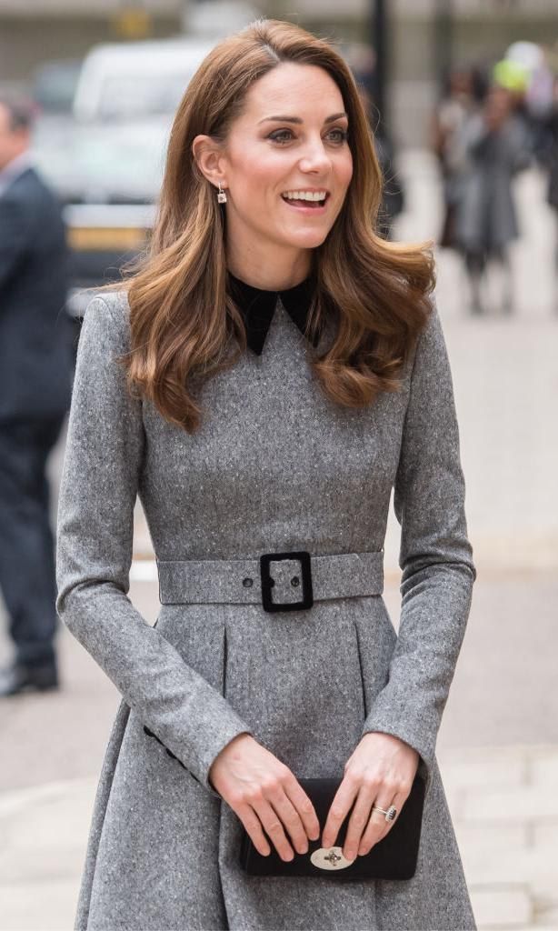 Kate Middleton in a gray dress with a black clutch