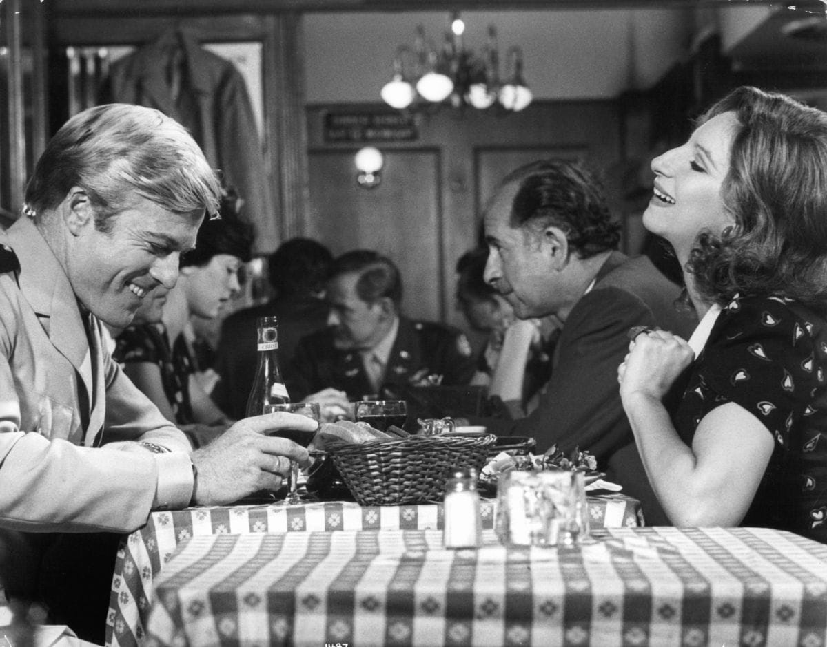 Robert Redford and Barbra Streisand sharing laughs in a scene from the film 'The Way We Were', 1973. 