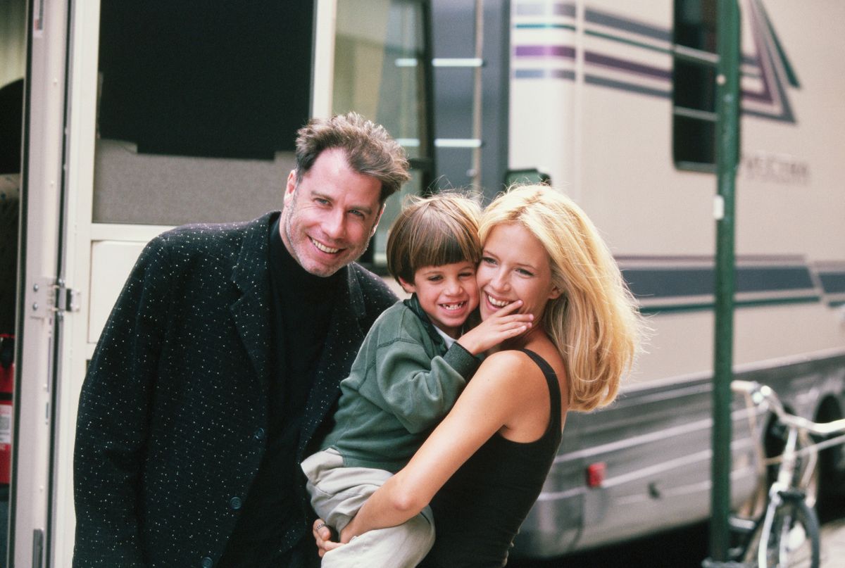 Actress Kelly Preston gets a visit from husband John Travolta (L) and son Jett while on location filming the 1997 motion picture "Addicted to Love."