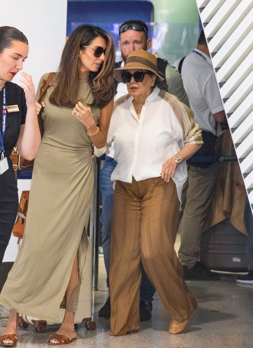 Baria looked elegant in a flowing white blouse, wide-leg brown trousers and a woven sun hat.