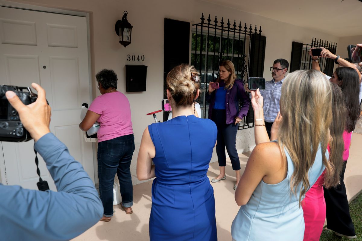 Members of the media crowd around the front door as people enter the home where Perez Hilton was found after he appeared to harm himself