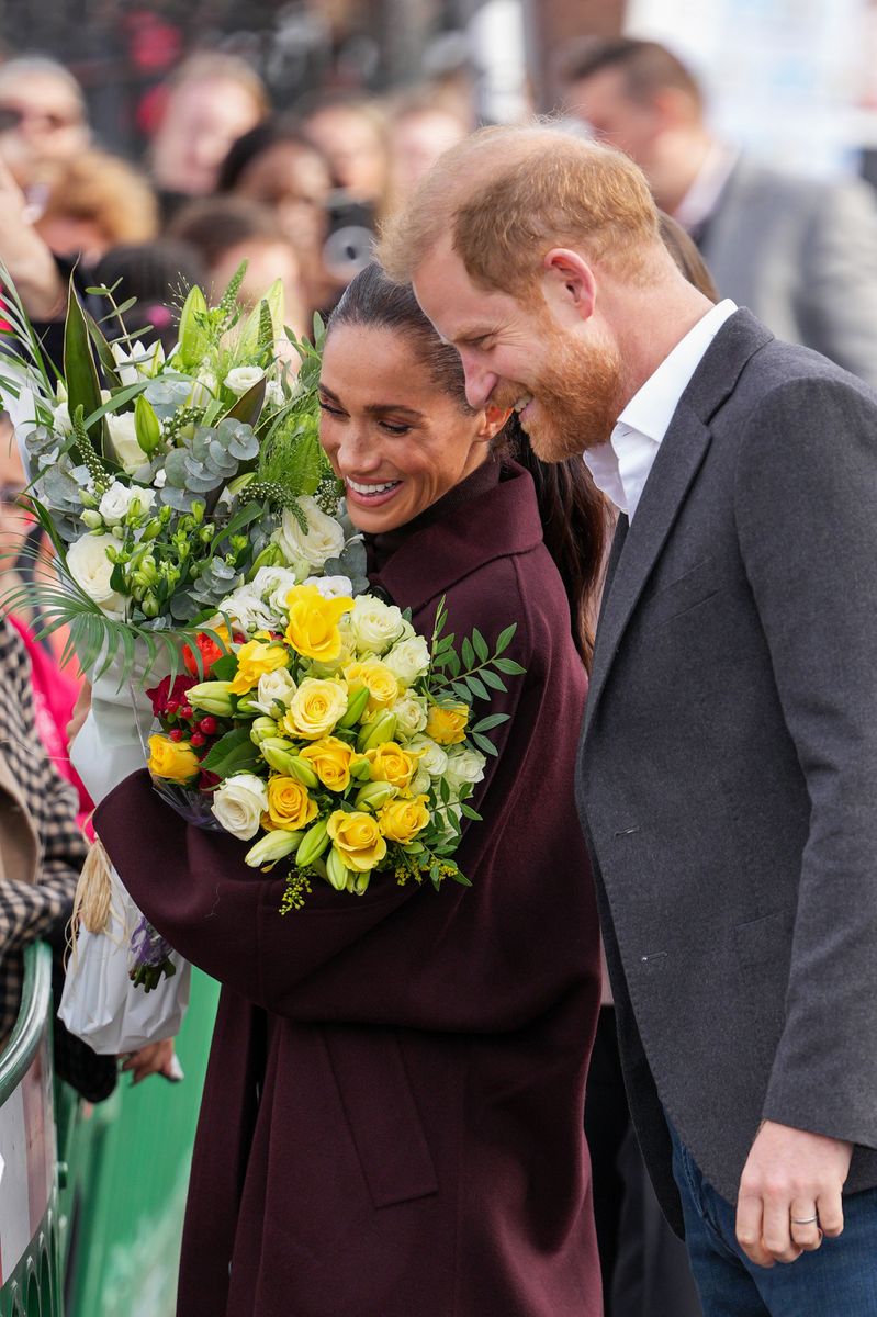 Meghan, Duchess of Sussex holds a bouquet of flowers as she and Prince Harry, Duke of Sussex arrive at the Community Recording Studio (CRS), a youth and community charity that offers a wide range of creative activities, sports, mentoring and youth development programmes.