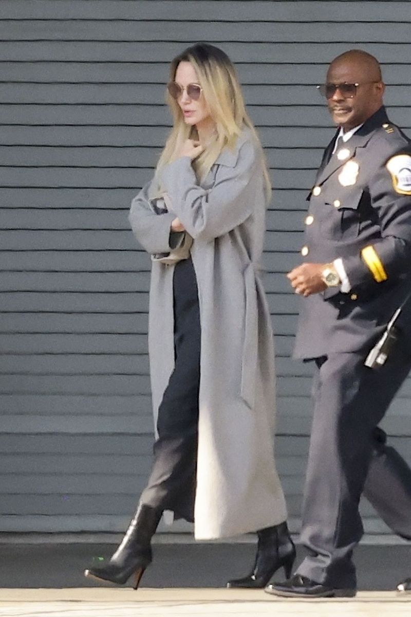 Angelina rocked a grey coat and amazing boots