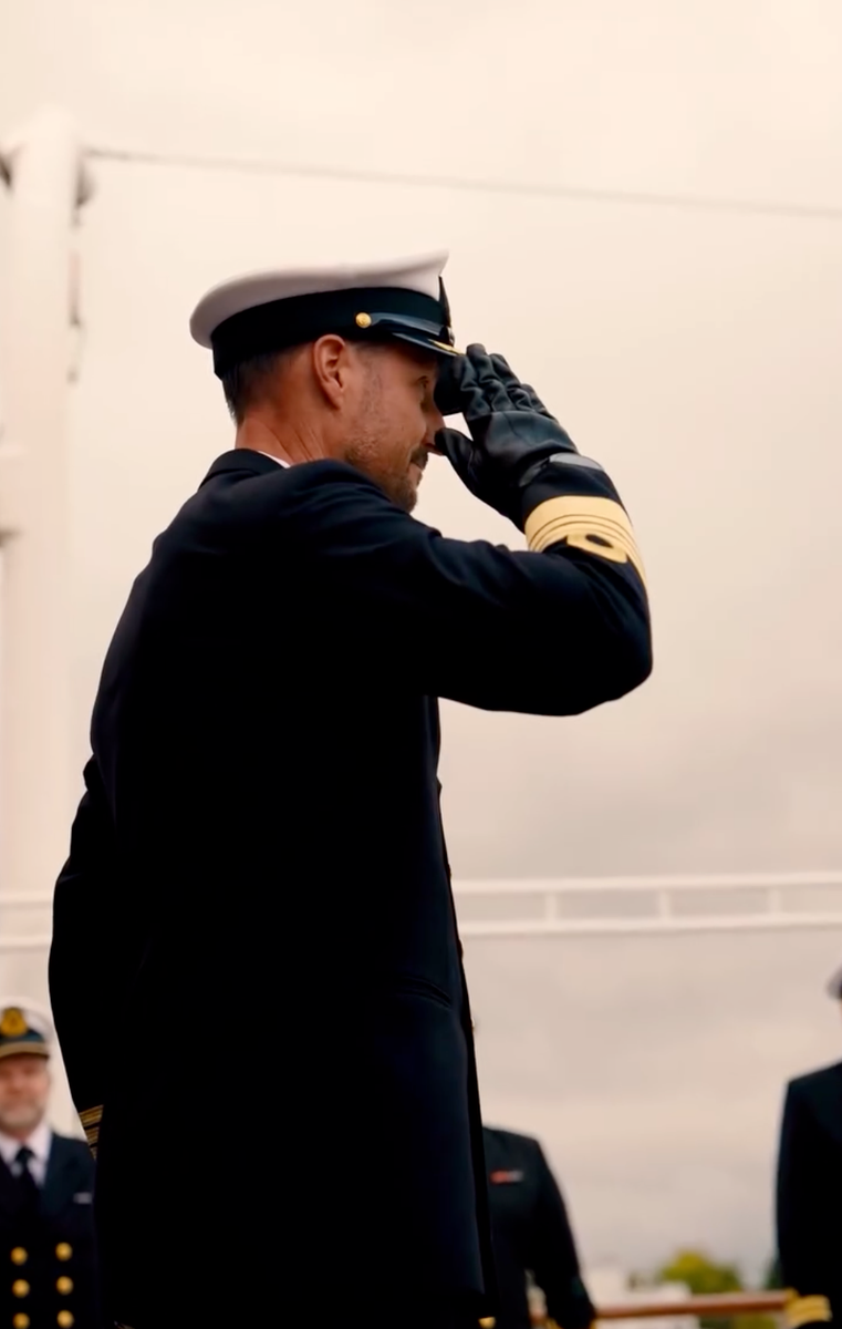 King Haakon salutes during a ceremony marking the end of the Royal Yacht Norge's 2026 season.