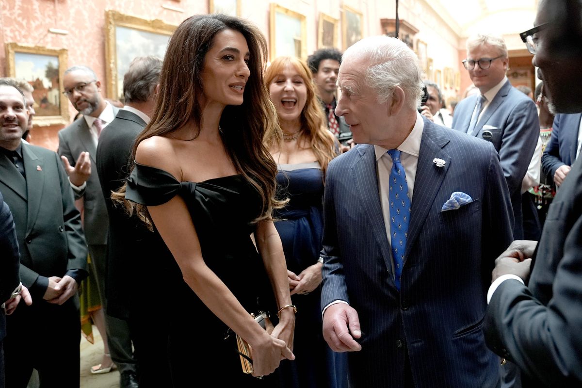 LONDON, ENGLAND - JUNE 25: Amal Clooney speaks with King Charles III attend a reception for the winners of the King's Trust Awards 2025 at Buckingham Palace on June 25, 2025 in London, England. (Photo by Stefan Rousseau-WPA Pool/Getty Images)