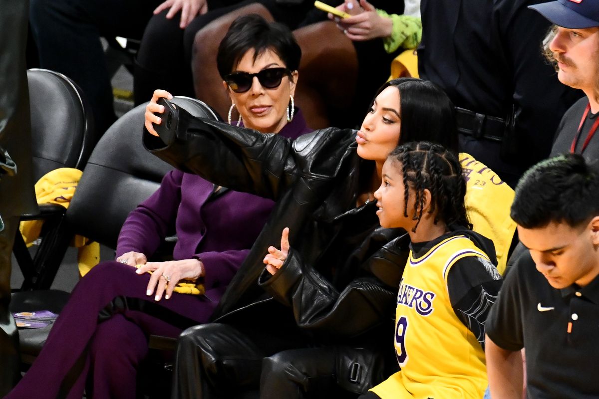 Kris Jenner watches Kim Kardashian takes a selfie with Saint West during a basketball game between the Los Angeles Lakers and the Memphis Grizzlies at Crypto.com Arena on April 24, 2023 in Los Angeles, California. (Photo by Allen Berezovsky/Getty Images)