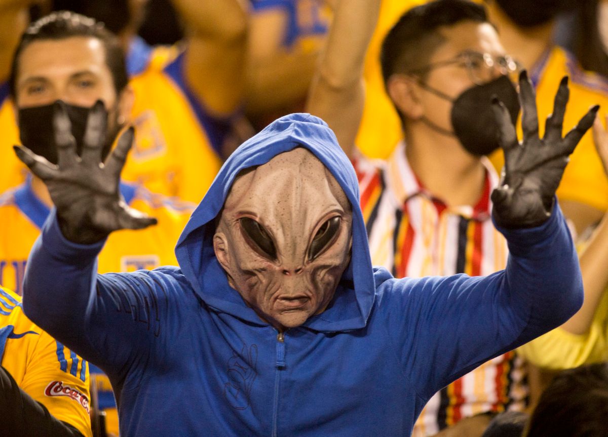 A Tigres fan dressed as an alien cheers during the Mexican Apertura 2021 football match between Guadalajara and Tigres at the Universitario stadium in Monterrey, Mexico, on October 30, 2021. (Photo by Julio Cesar AGUILAR / AFP) (Photo by JULIO CESAR AGUILAR/AFP via Getty Images) 