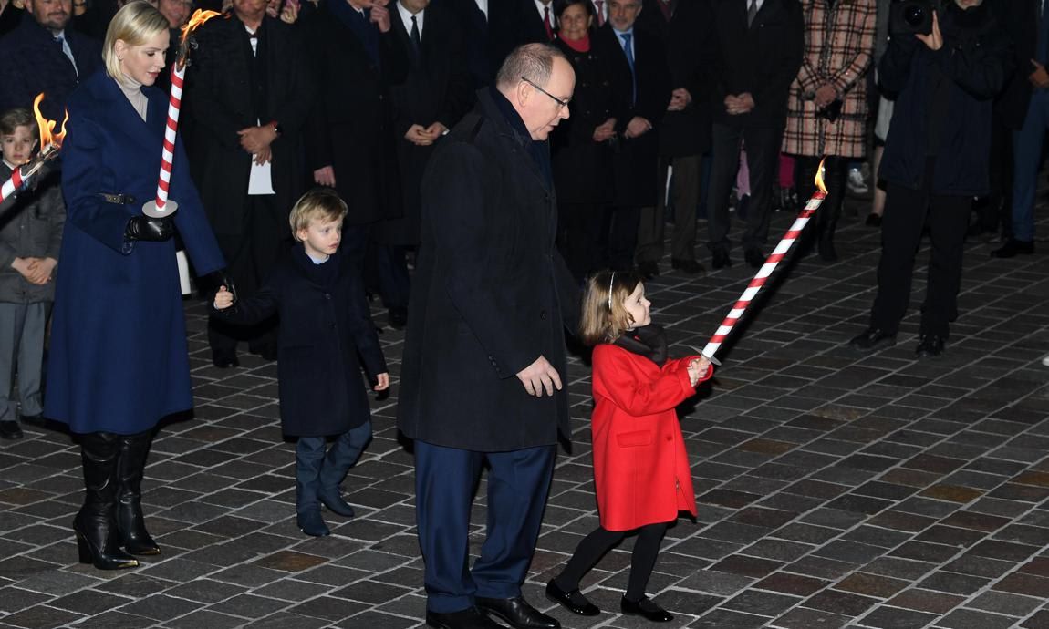 The ever-stylish Charlene kept warm in a blue double-face coat by Louis Vuitton.
