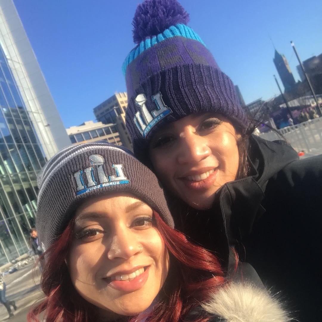 Dascha Polanco and her sister Jessica taking a selfie with Super Bowl beanies