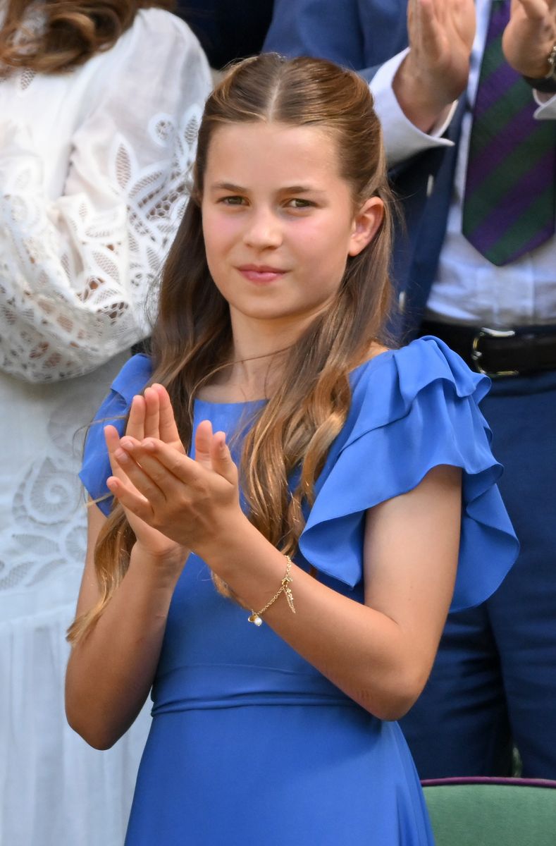 Princess Charlotte charmed spectators in a vibrant blue dress and white ballet flats, a look that echoed one of her mother's past Wimbledon outfits.