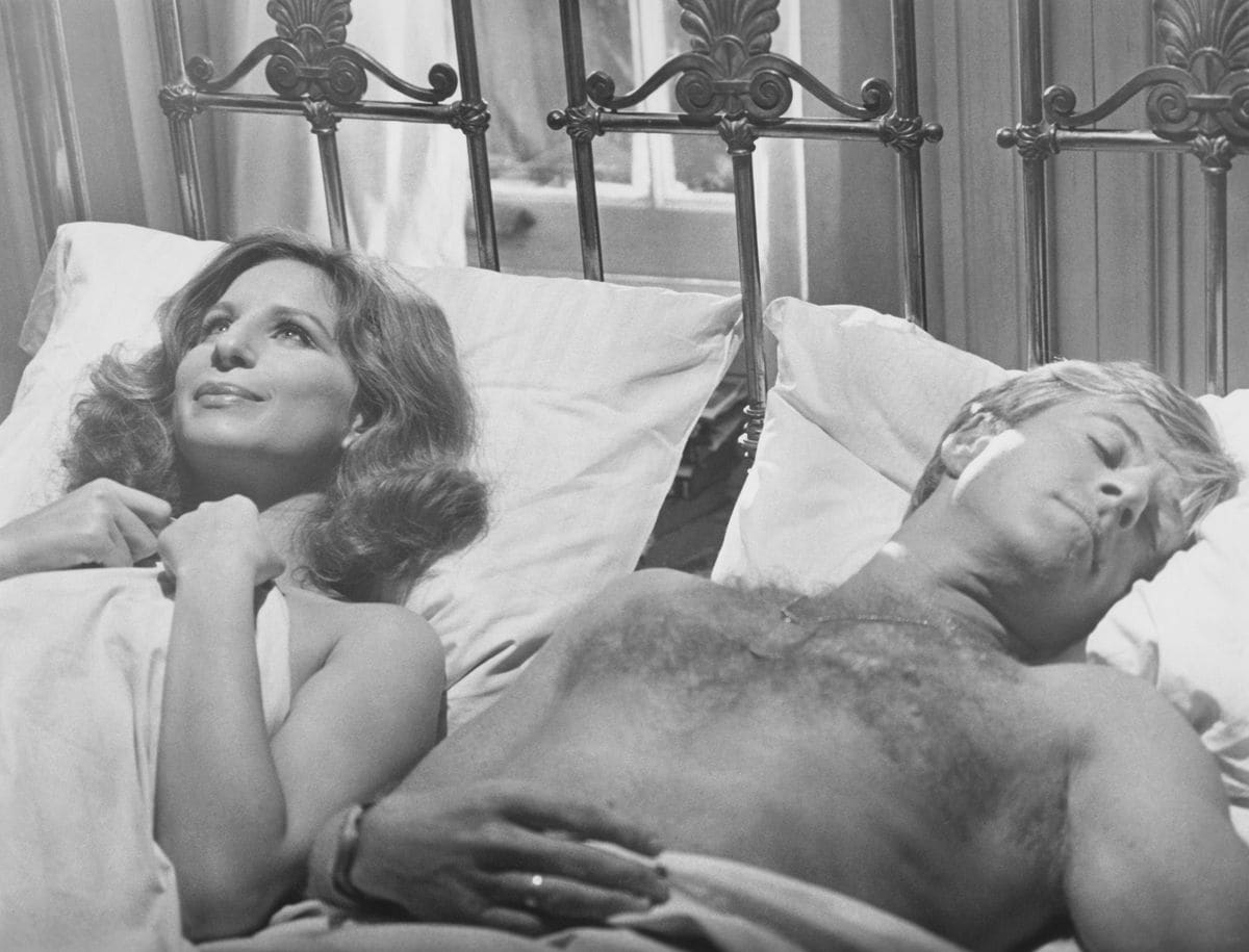 Barbra Streisand lying in bed next to Robert Redford from 'The Way We Were' 1972. 