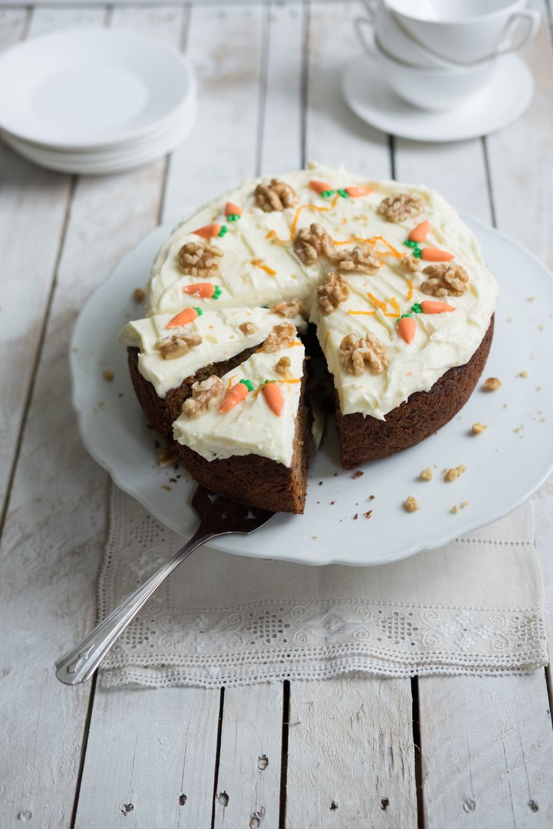 Classic home made carrot cake decorated with cream cheese icing, walnuts and miniature marzipan carrots. Contains fresh grated carrots