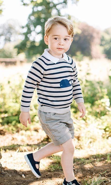 In the first portrait George can be seen walking through the gardens at his home in a striped whale print jumper and taupe shorts.
<br>Photo: PA