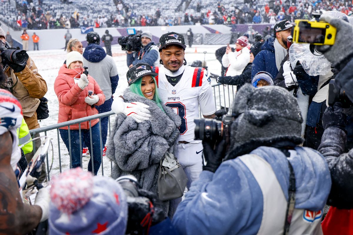 Cardi B and Stefon Diggs #8 of the New England Patriots celebrate after the AFC Championship game.