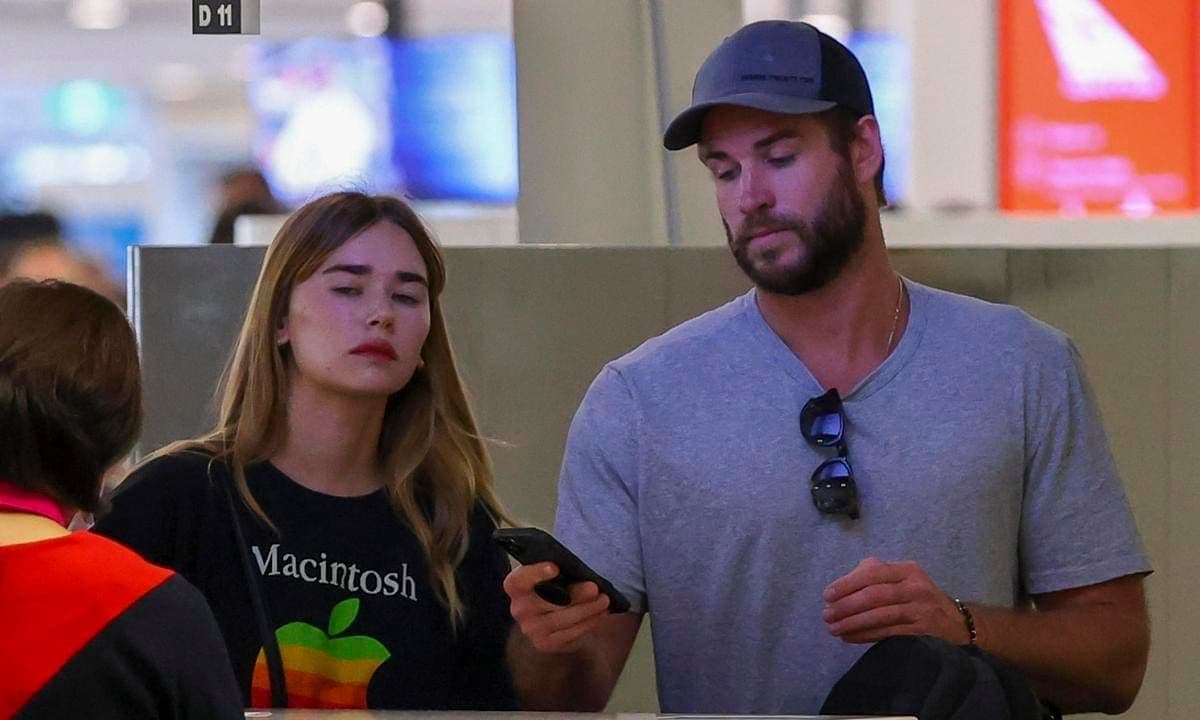 Liam Hemsworth catches a flight with his girlfriend Gabriella Brooks